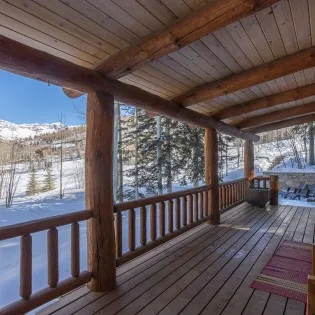 mountain village vacation rental yellow brick cabin porch