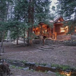 mountain village vacation rental yellow brick cabin stream